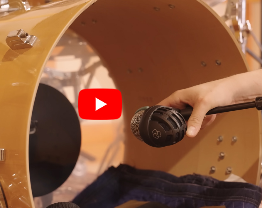 Oliver Roman demonstrating expert drum mic placement for the kick drum.