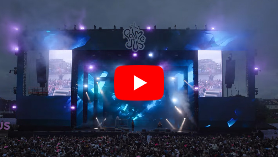 Image of Palmesus Festival, Norway showing nighttime shot of stage with dynamic lighting and crowd watching stage.